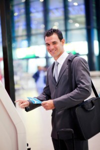 businessman using self help check in machine at airport