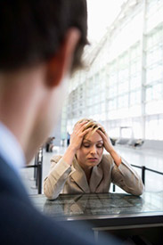 Businesswoman holding head in frustration